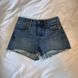 High waisted slightly distressed button fly shorts